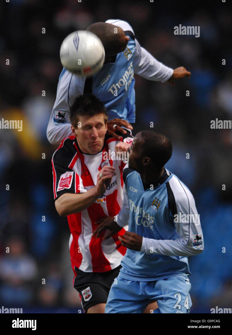 Southampton's Grzegorz Rasiak (center) battles for the ball with Manchester City's DaMarcus Beasley (right) and Sylvain Distin (top) Stock Photo