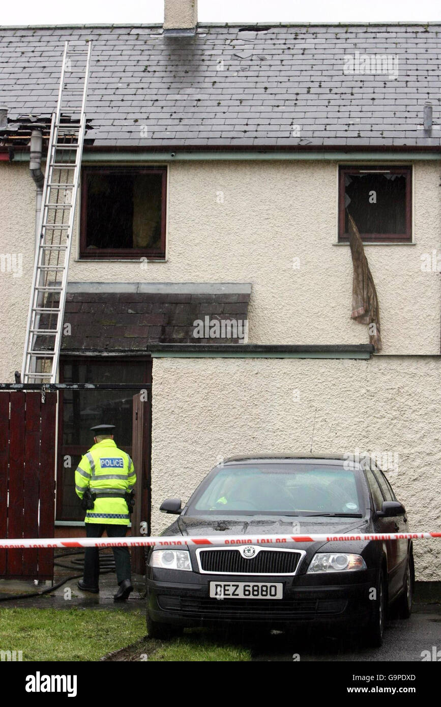 Strabane house fire. A policeman enters a house in Strabane, Co Tyrone