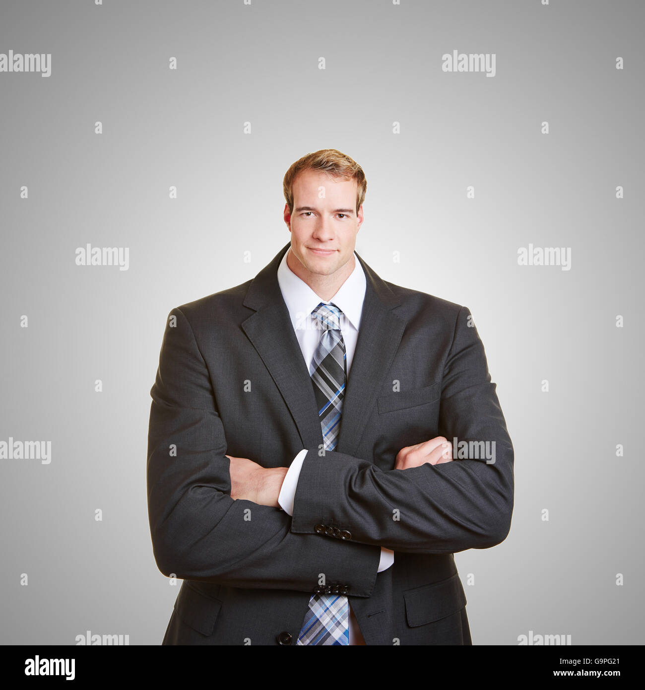 Funny business man with a small head and his arms crossed Stock Photo