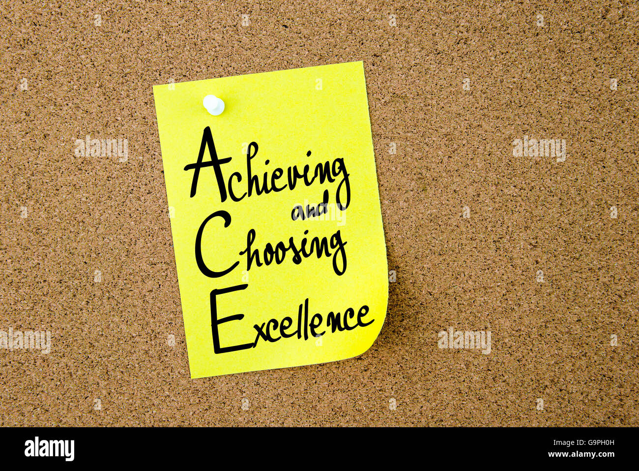 ACE Achieving and Choosing Excellence written on yellow paper note pinned on cork board with white thumbtacks, copy space available Stock Photo