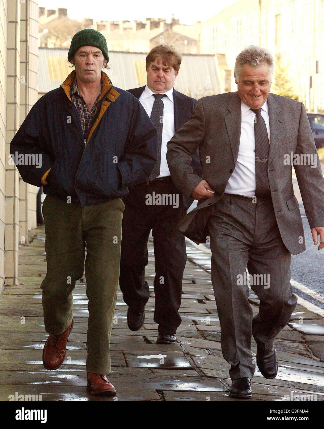 From left, 50-year-old Peter Smith, 56-year-old Derek Kokocinski and 62-year-old Jack Clarkson arrive at Burnley Crown Court. Stock Photo