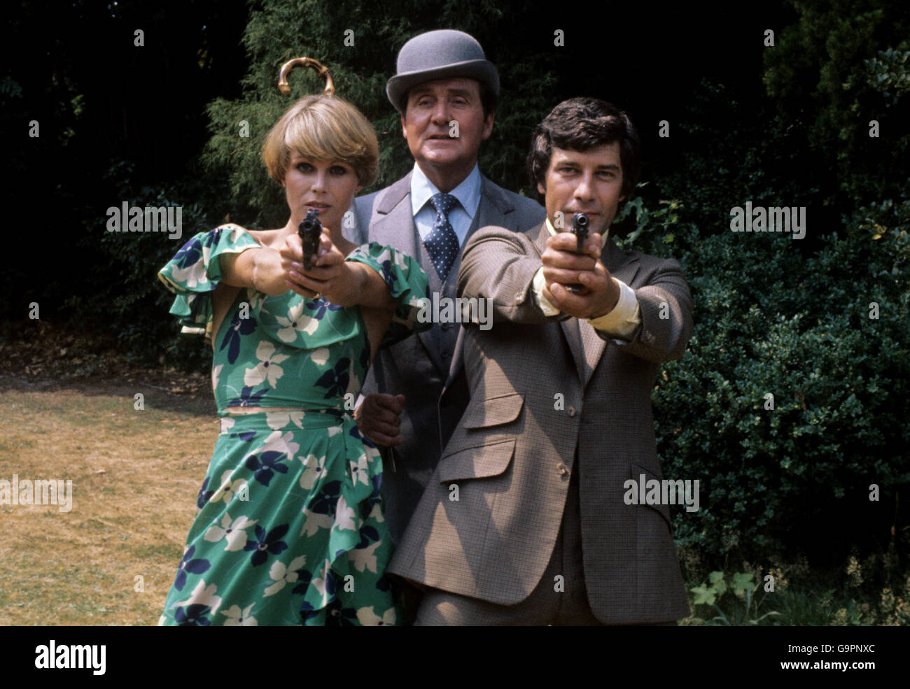 (L-R) Joanna Lumley, who plays Purdey, Patrick MacNee, who plays John Steed, and Gareth Hunt, who plays Mike Gambit, pictured during filming at Pinewood Studios Stock Photo