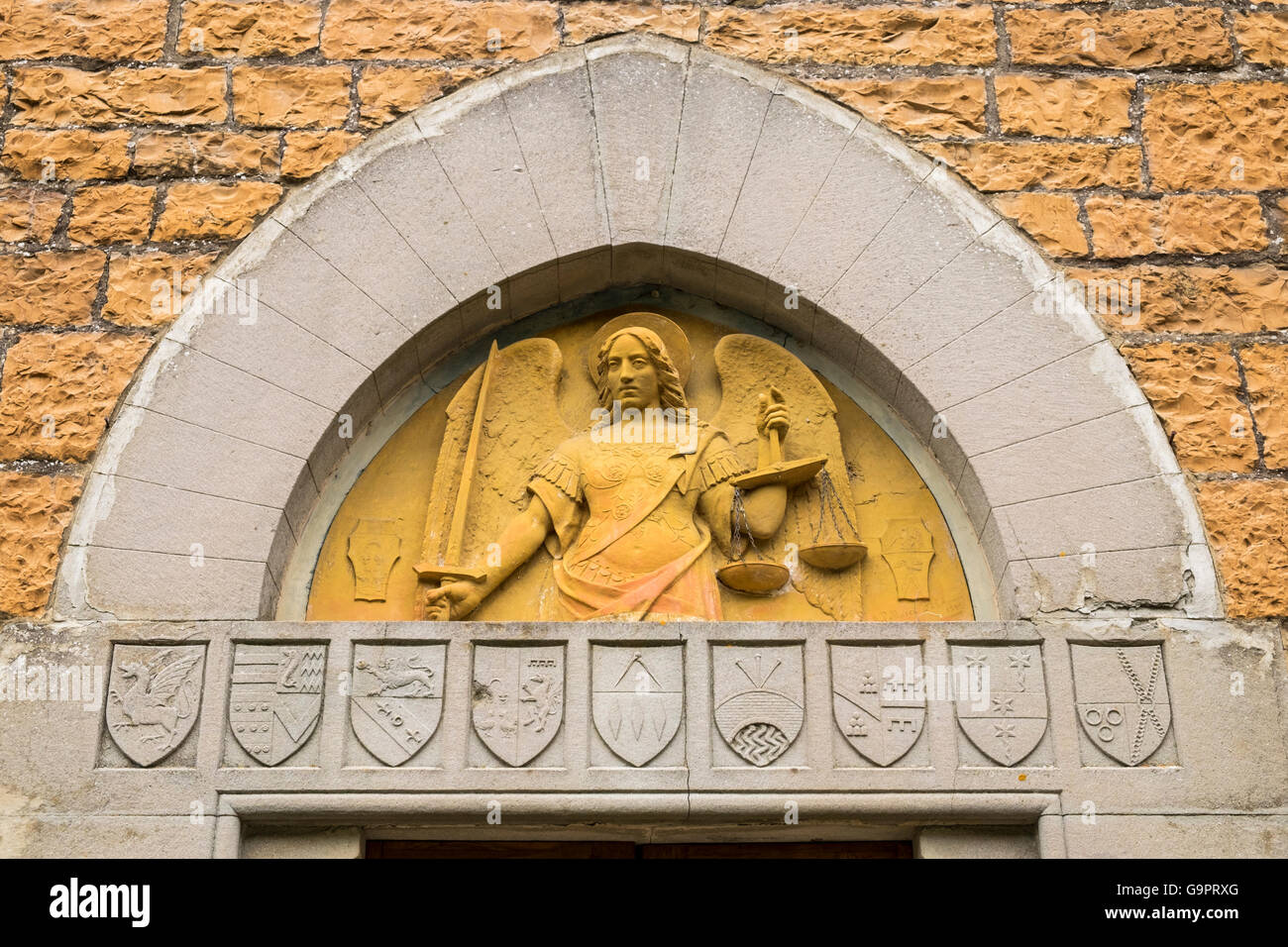Detail of the relief statue of San Michelle above the door of the church at San Michelle a Muscoli, near Fiesole, Tuscany, Italy Stock Photo