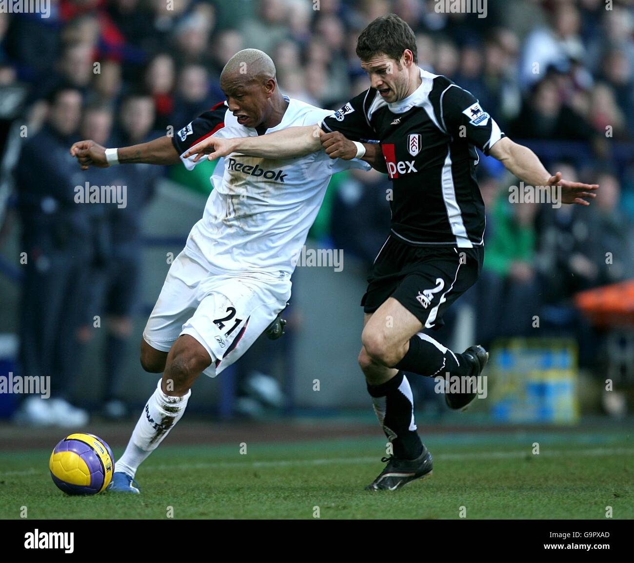 Soccer - FA Barclays Premiership - Bolton Wanderers v Fulham - The Reebok Stadium. Bolton Wanderers' El-Hadji Diouf (l) and Fulham's Moritz Volz (r) battle for the ball Stock Photo