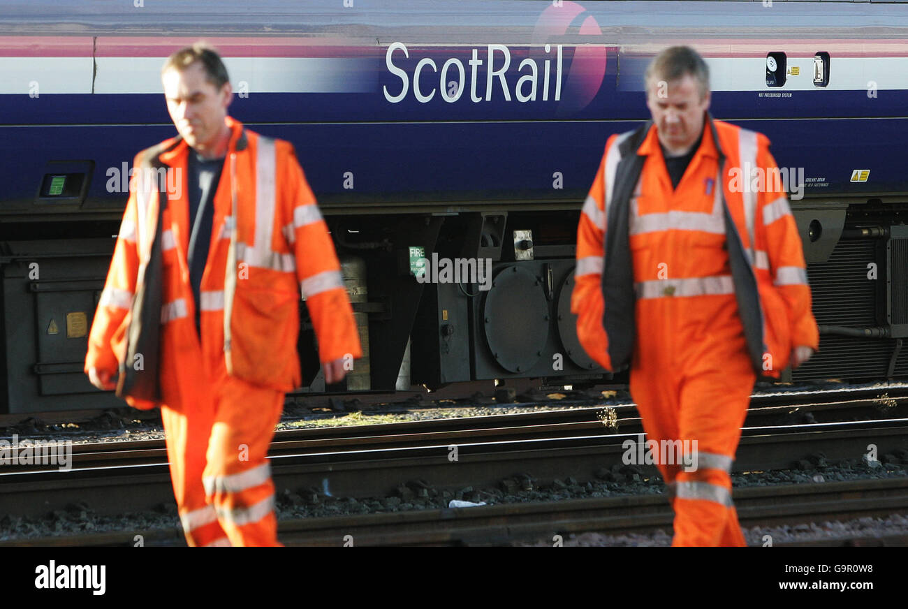 Scotrail Engineering Engineers underneath a train at work after Tavish Scott M.S.P Transport ...