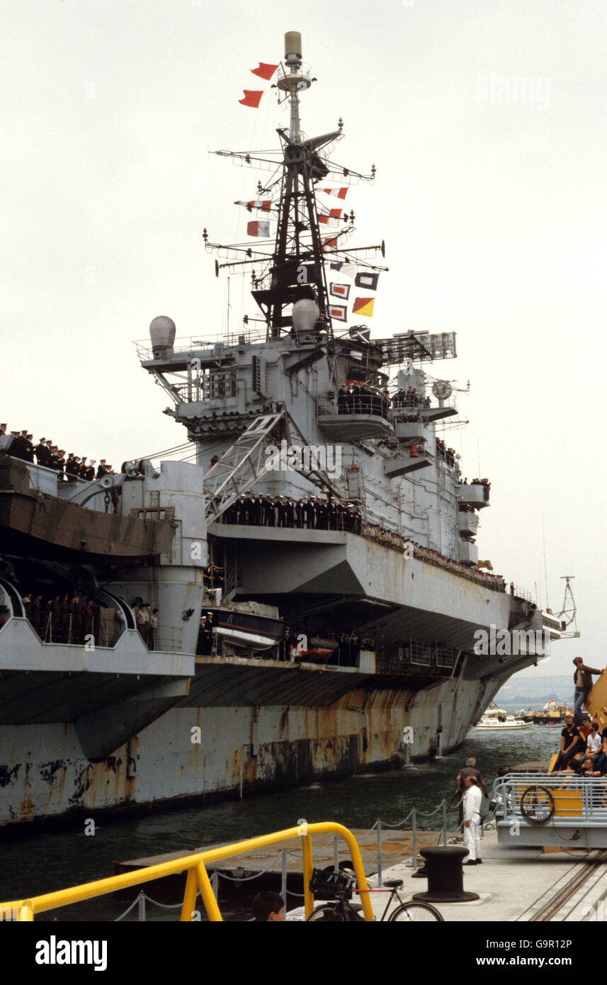 The Falklands task force flagship HMS Hermes is inched alongside at Portsmouth on her return from the Atlantic. Stock Photo