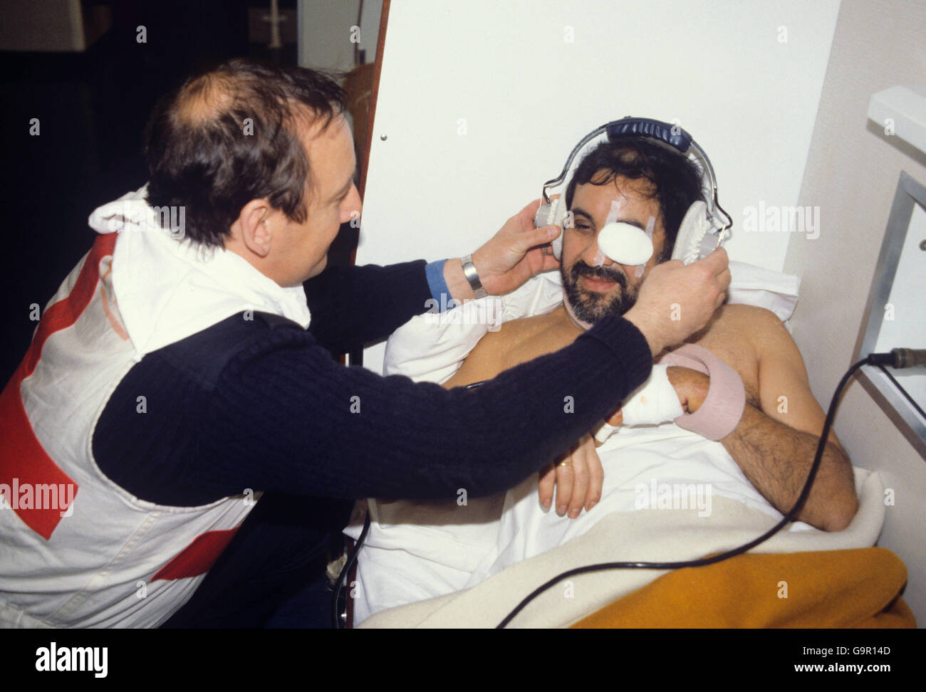 A medical officer tends to an injured Argentine seaman in the sick bay of HMS Invincible. Two seamen were injured and put in the sick bay after the fishing vessel Narwal was sunk. Stock Photo