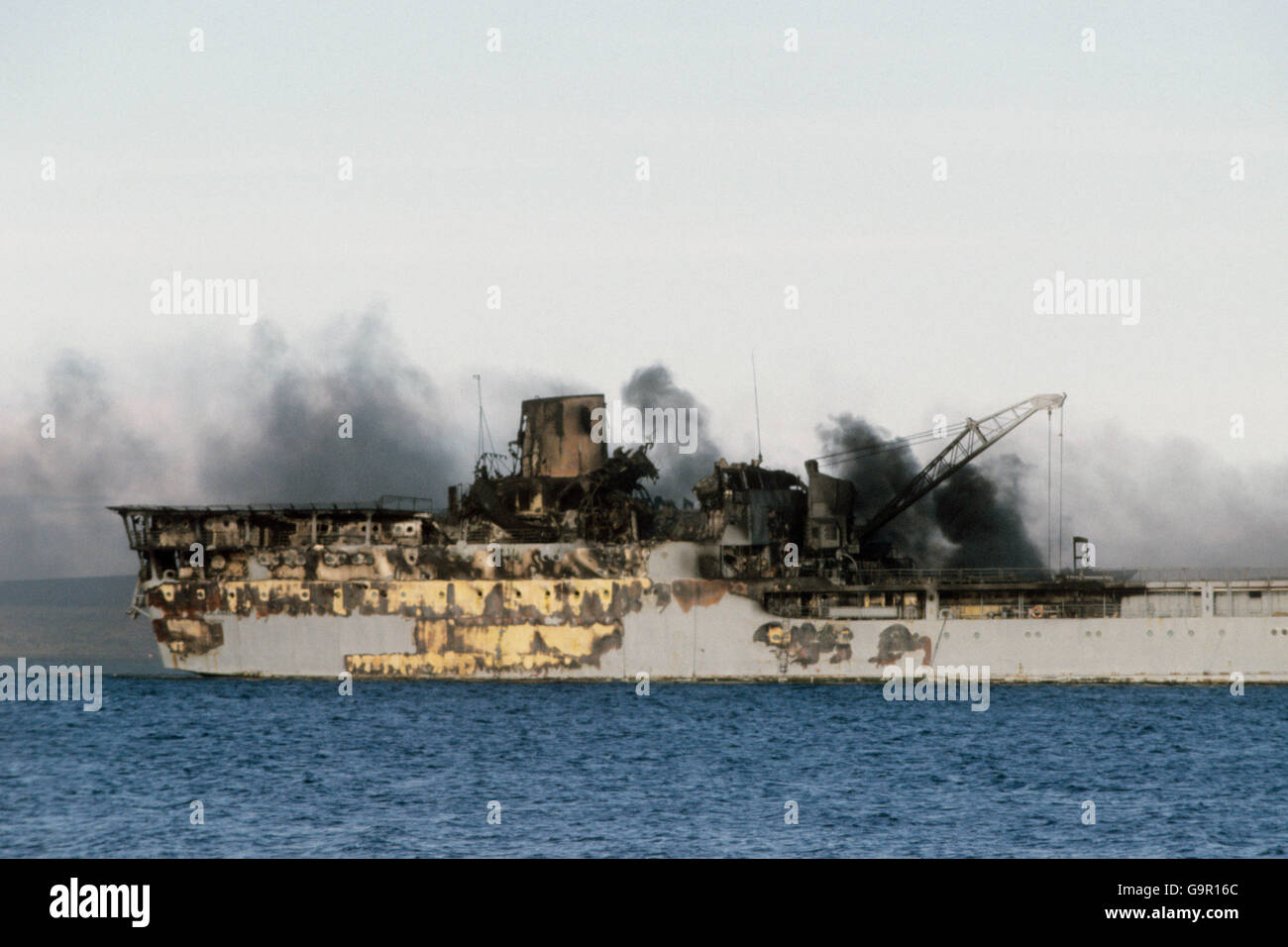 Smoke rising from the smouldering burnt out remains of the Sir Galahad. Stock Photo