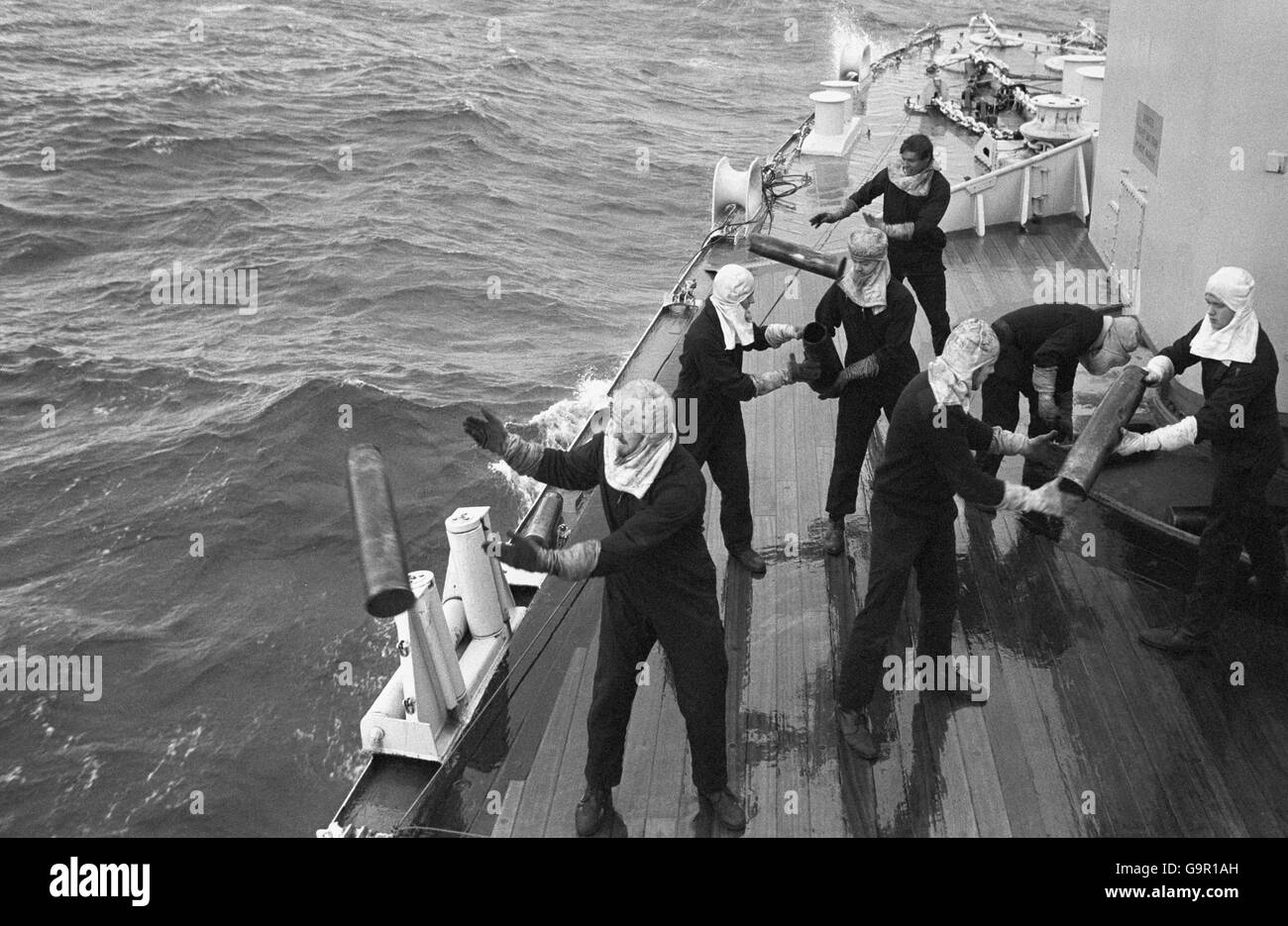 Crew from a Falklands Task Force ship throw empty 4.5 shell cases ...