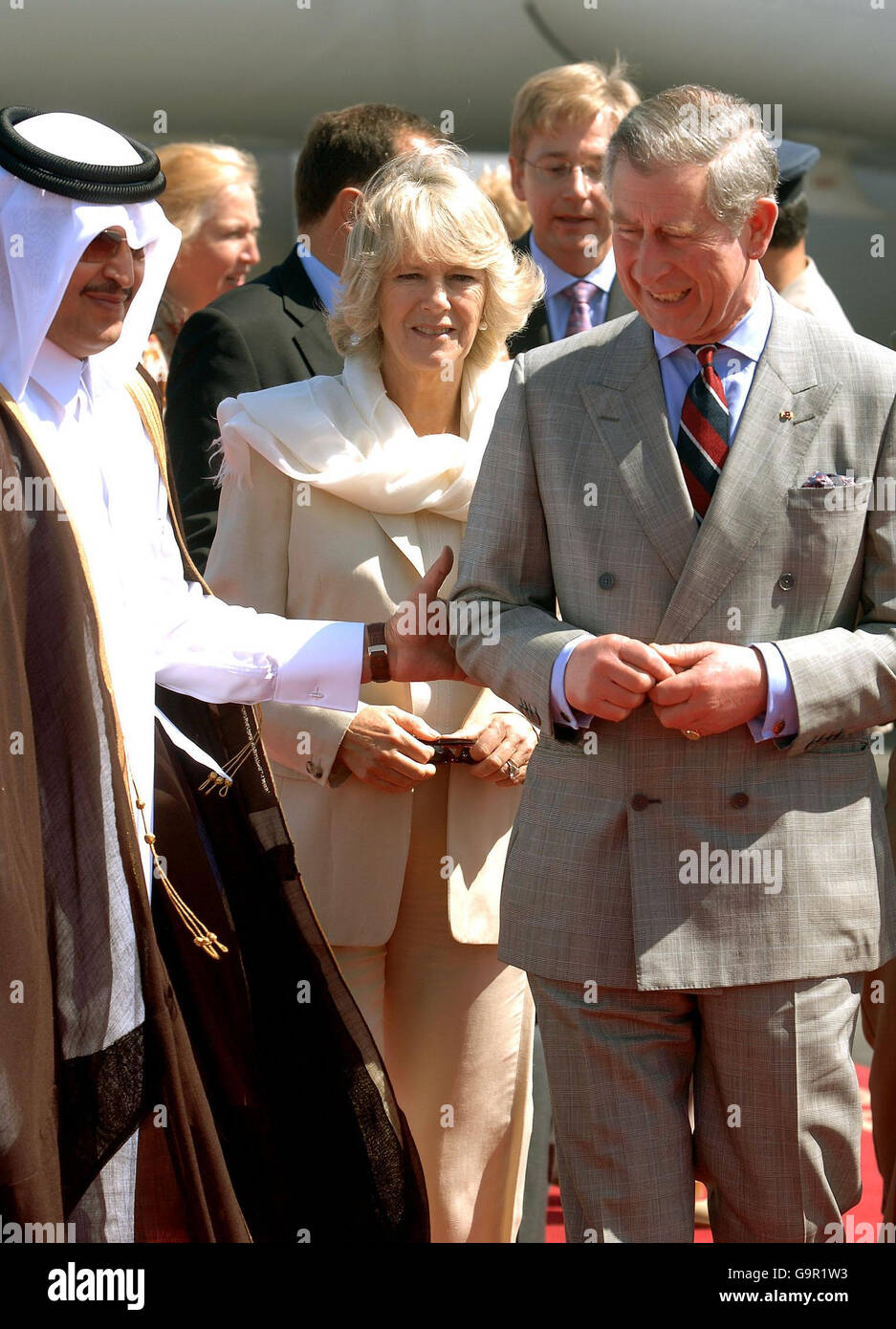 The Prince of Wales walks with Sheikh Hamad Bin Suhaim (left) the Minister of State for ruling family affairs, with the Duchess of Cornwall behind them, after arriving in the Gulf State of Qatar, this morning. Stock Photo