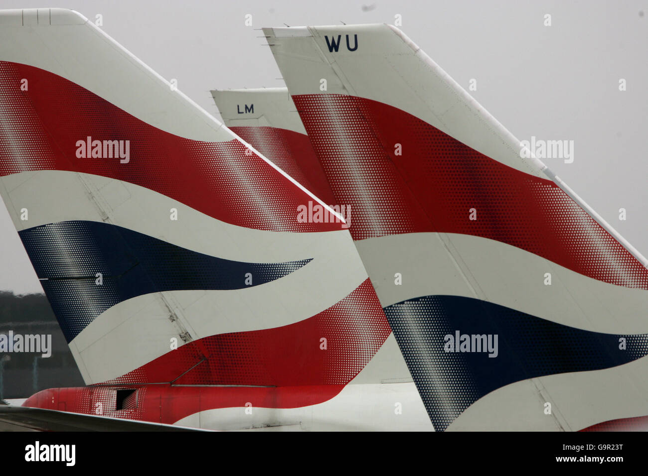 Generic transport pics. The tail fins of British Airways' aircraft parked at Terminal Four of London's Heathrow Airport. Stock Photo