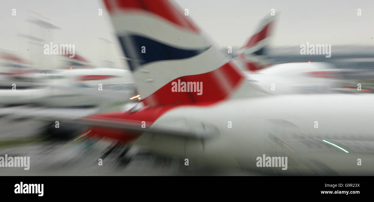 The tail fins of British Airways' aircraft parked at Terminal Four of London's Heathrow Airport. Stock Photo