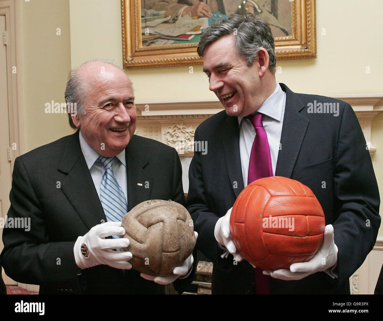 FIFA's President Sepp Blatter (L) holds the ball used in the 1930 Football  World Cup as he meets in central London with Britain's Chancellor Gordon  Brown (R), who holds the 1966 Football