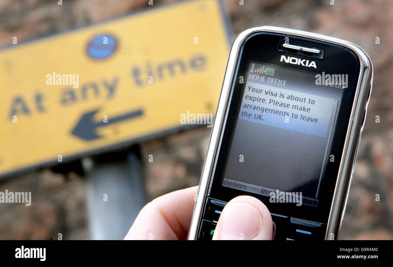 Photo illustration of a mobile phone displaying a message similar to the one which will be intended for immigrants, reading: 'Your visa is about to expire, please make arrangements to leave the UK.' Stock Photo