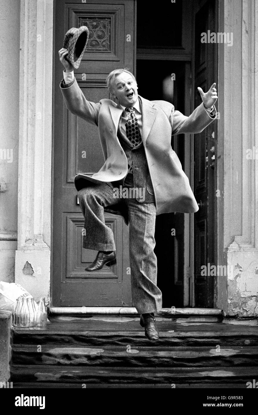 Jumping for joy outside his London home is actor John Inman - Mr Humphries in the BBC TV series 'Are You Being Served'. John, who sprang to fame through the comedy series with his 'I'm Free' catchphrase, was today named Joint BBC TV Personality of 1976 in the Variety Club of Great Britain Awards. In October he gets his own Thames TV sit-com series, 'Odd Man Out' Stock Photo