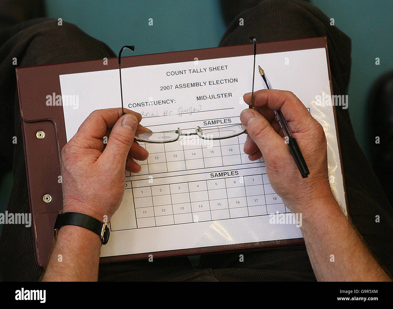 A tallyman at the Seven Towers Leisure Centre in Ballymena, Co.Antrim, counts the votes to elect 108 new members of the Stormont Assembly. Stock Photo