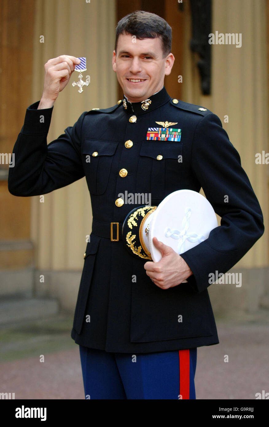Helicopter pilot Major William Chesarek, of the US Marine Corps, holds his Distinguished Flying Cross outside Buckingham Palace, London, after collecting it from Britain's Queen Elizabeth II. Stock Photo