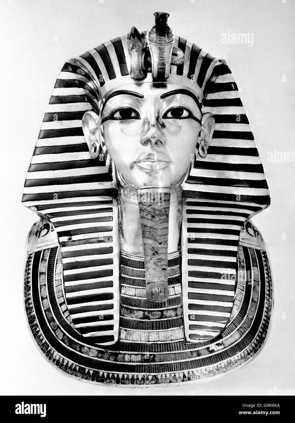 Amoung the treasures of Tutankhamun is this funeral mask. Probably an exact likeness, it is the finest ever found, solid gold, inlaid with semi-precious stones and glass. It is 15 inches wide at the shoulders Stock Photo