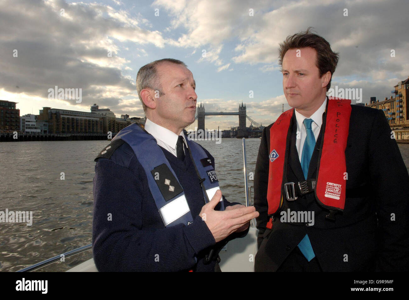 Conservative Leader David Cameron (right) talks to Inspector Danny Lamb who is in charge of Marine Counter-terrorism and Security, onboard the Patrick Colquhoun, a logistic support vessel, during the journey up the Thames to Westminster. Stock Photo
