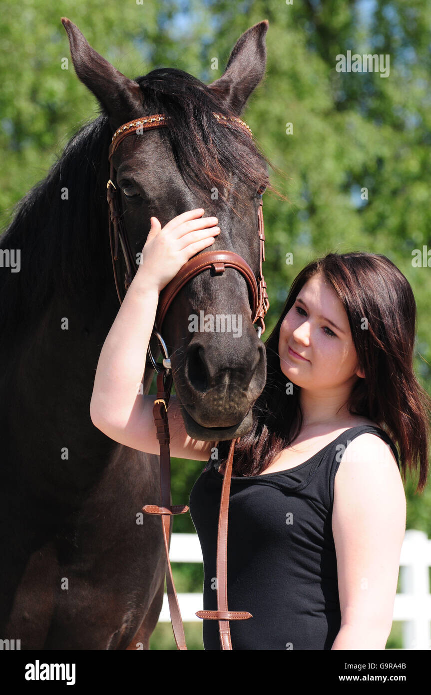 Girl with Horse / Thouroughbred, bridle Stock Photo