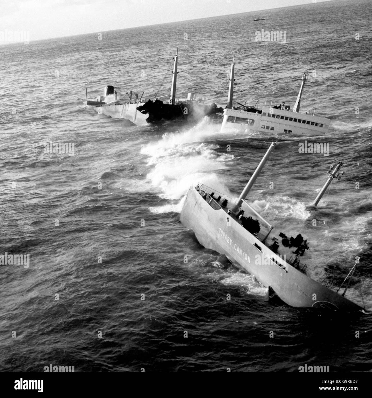 Now in three pieces - aft, bridge and forward section, the wreckage of the Torrey Canyon is seen being pounded by the seas on the Seven Stones reef of Land's End, Cornwall in this picture taken from a Royal Navy helicopter. Stock Photo