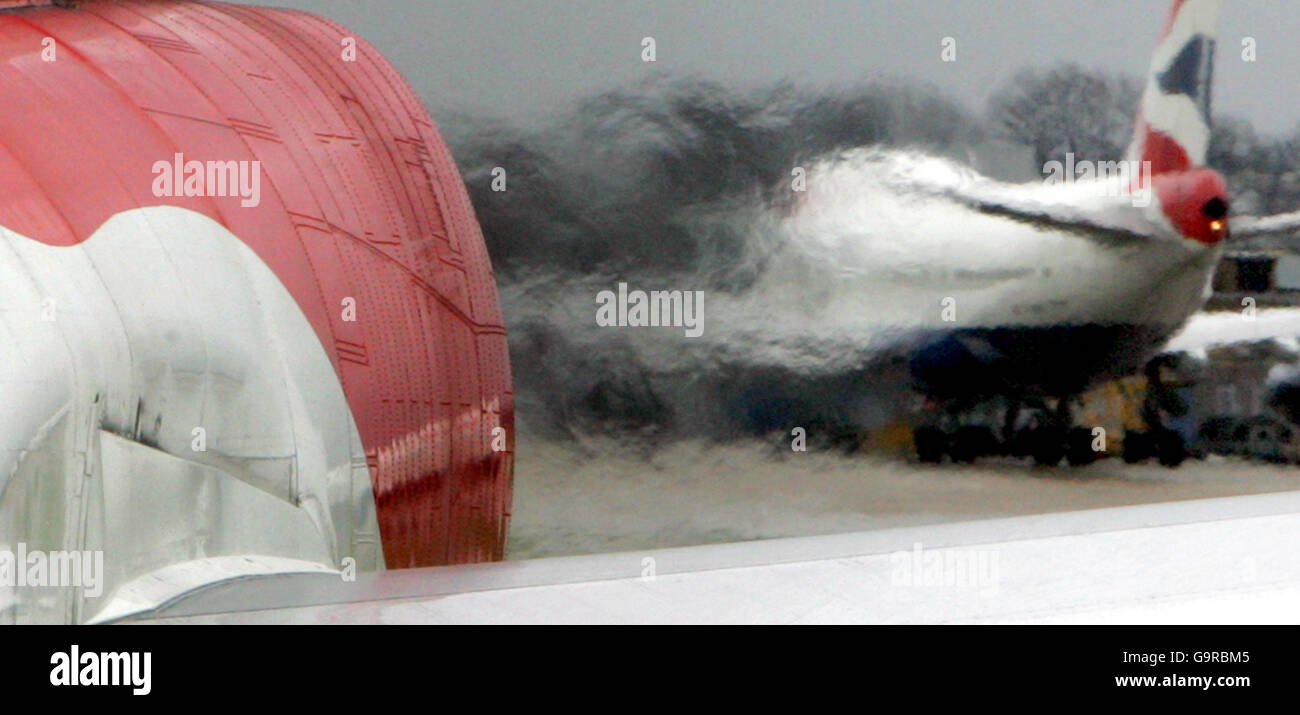 A view of adjacent aircraft is distorted by the heat from the engines of a British Airway's Boeing 747 after landing at Heathrow. Stock Photo