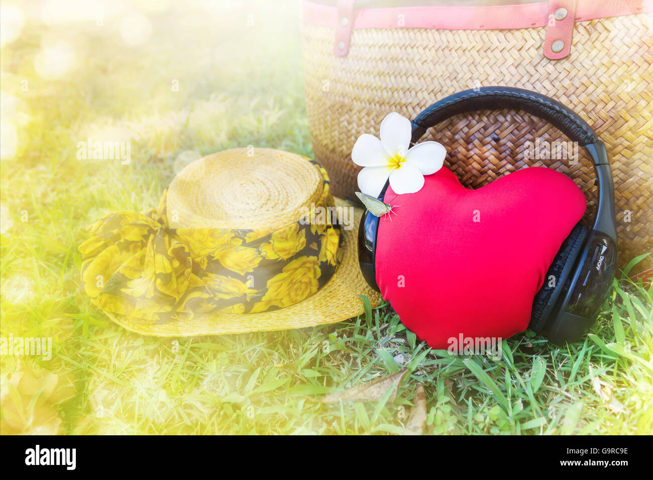 Red heart listen to music via headphone and summer hat and bag in background with relax fresh summer feeling , sweet and lovely  Stock Photo