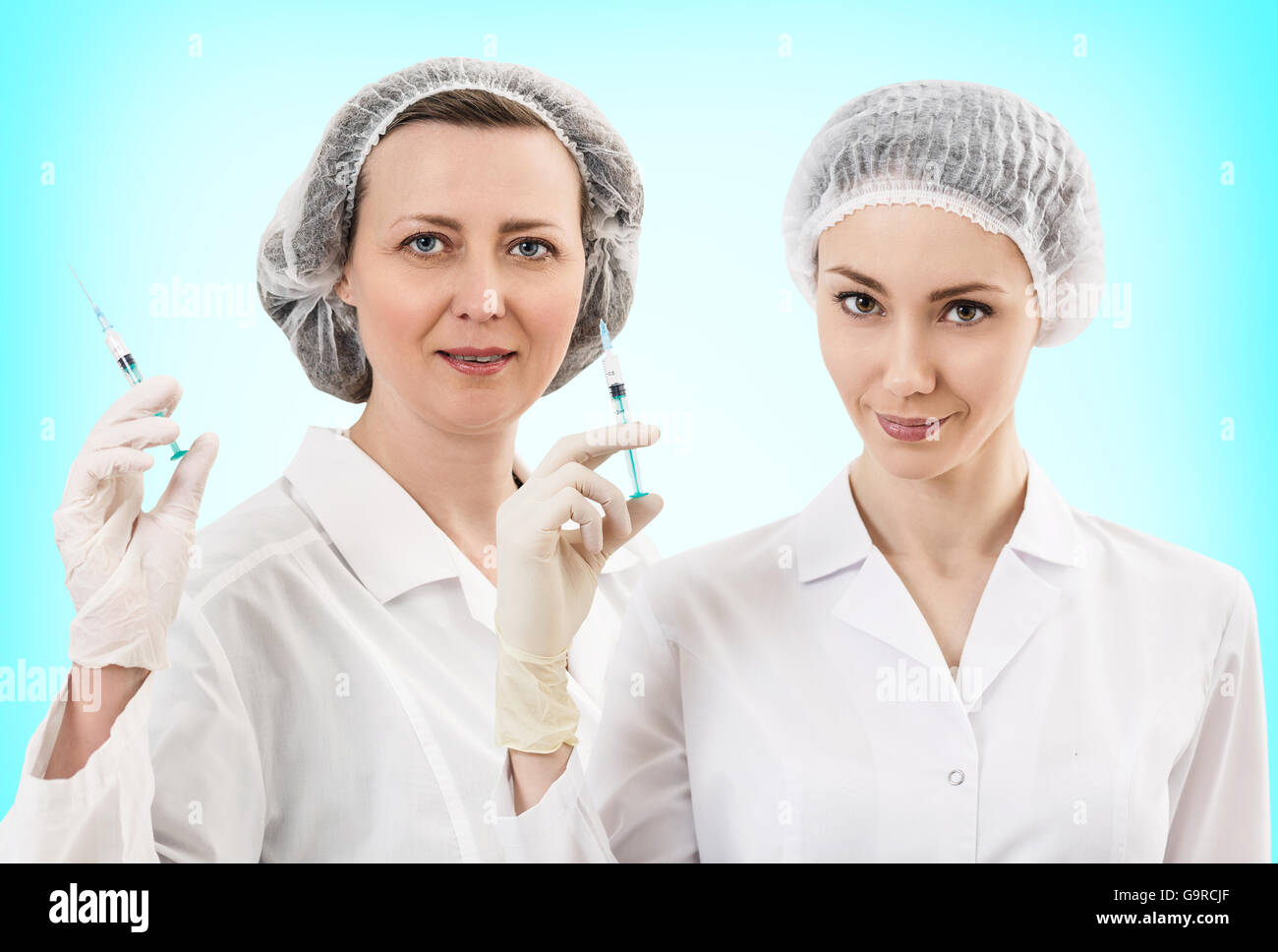 Portrait of serious doctor woman holding syringe Stock Photo