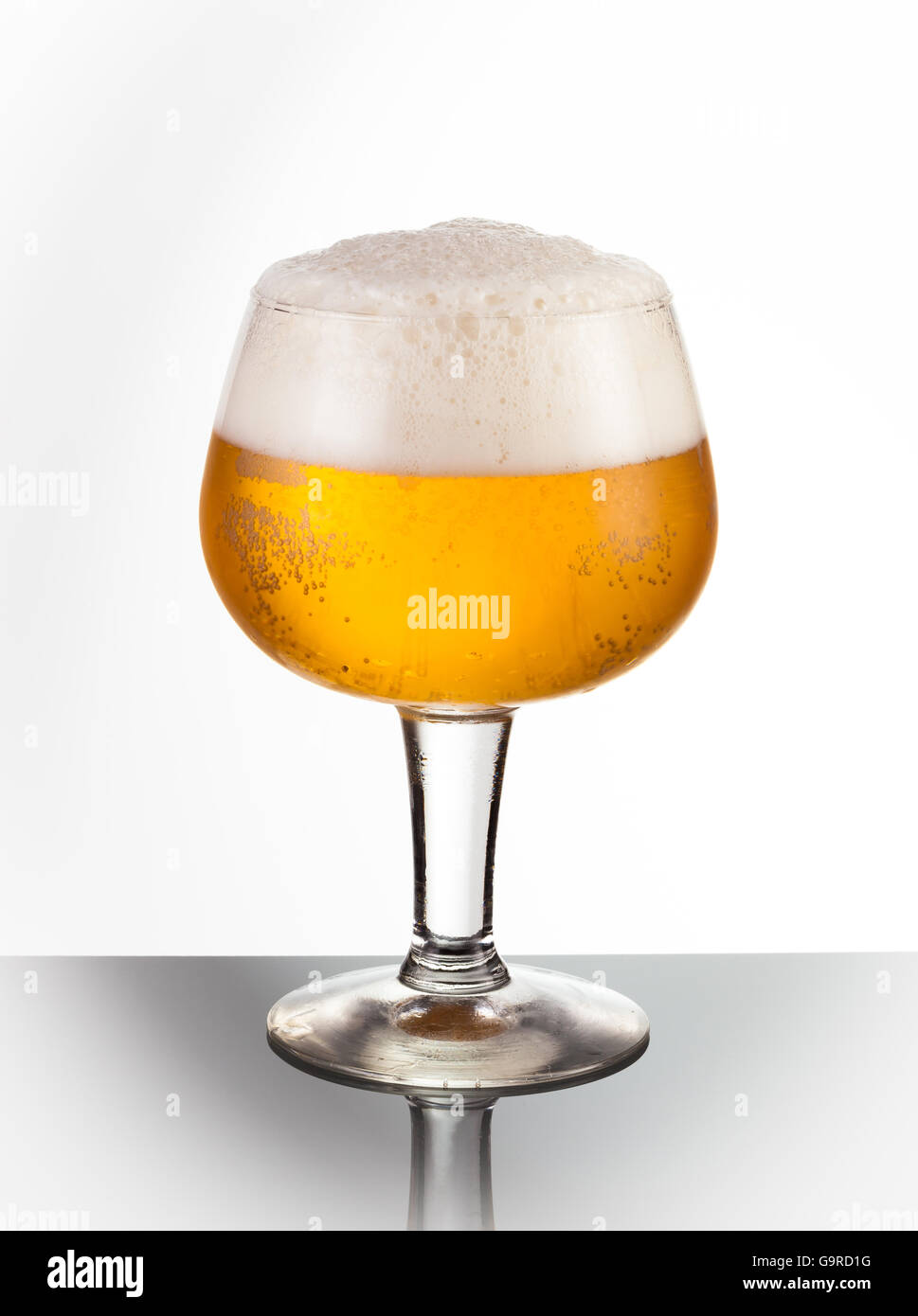 An ice cold snifter glass of refreshing beer Stock Photo
