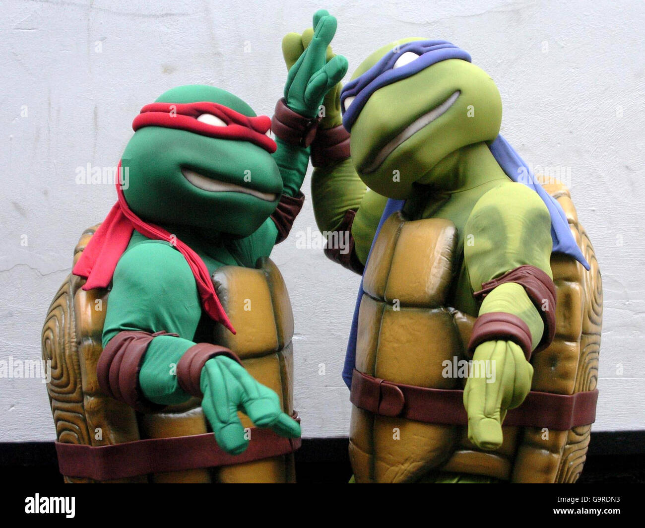 Teenage Mutant Ninja Turtles launch new movie. Teenage Mutant Ninja Turtles Raphael, left, and Michelangelo launch the new film, TMNT: The Movie, in London. Stock Photo