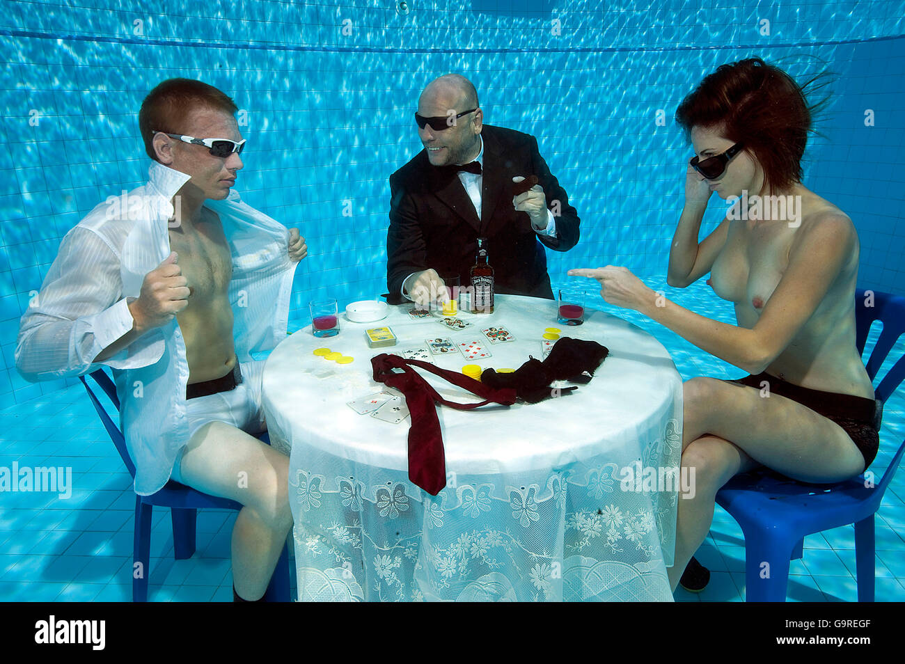Strippoker, card game, under water, in swimming pool / poker Stock Photo