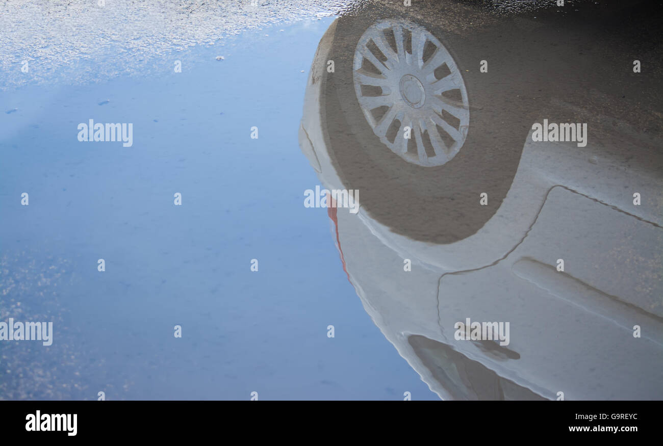 car reflected in a urban puddle Stock Photo - Alamy