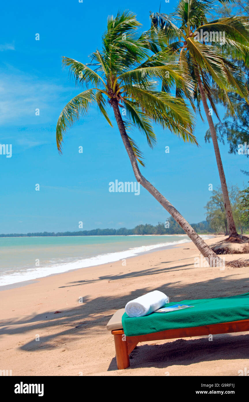 Beach lounger under palms,Thailand Stock Photo