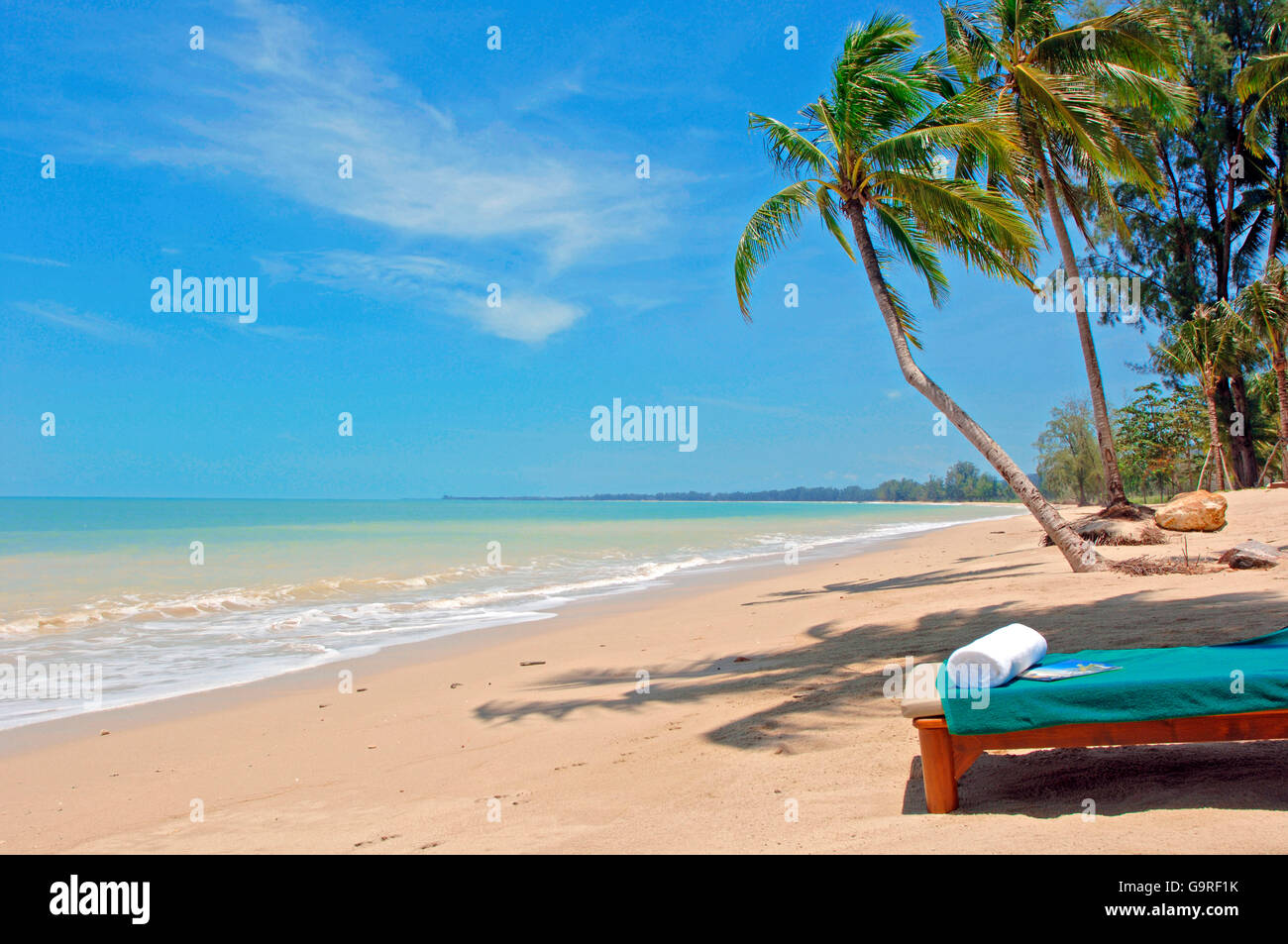 Beach lounger under palms,Thailand Stock Photo