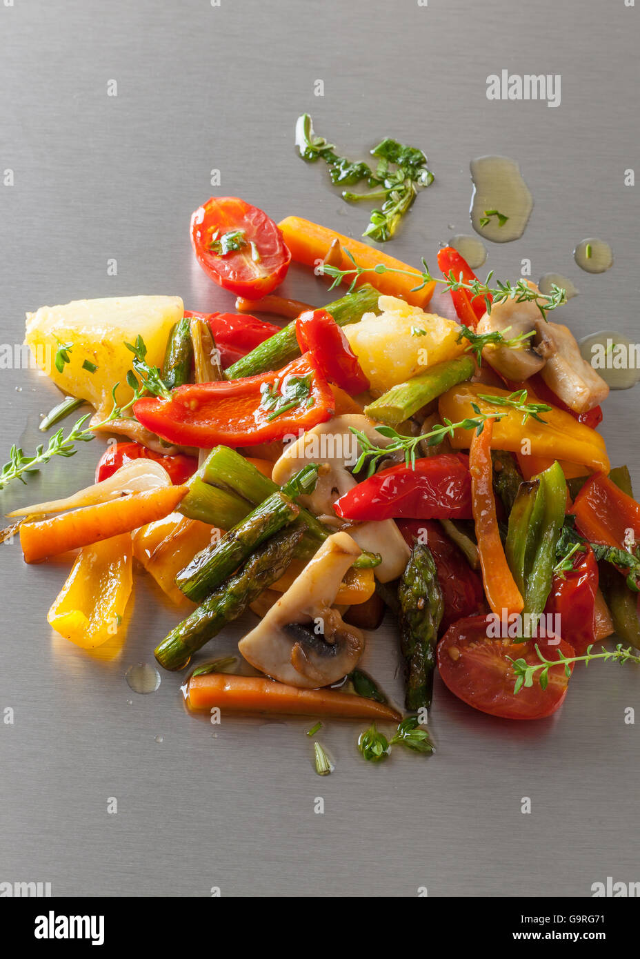 Grilled vegetables with spicy oil on a Japanese teppanyaki grill plate. Stock Photo