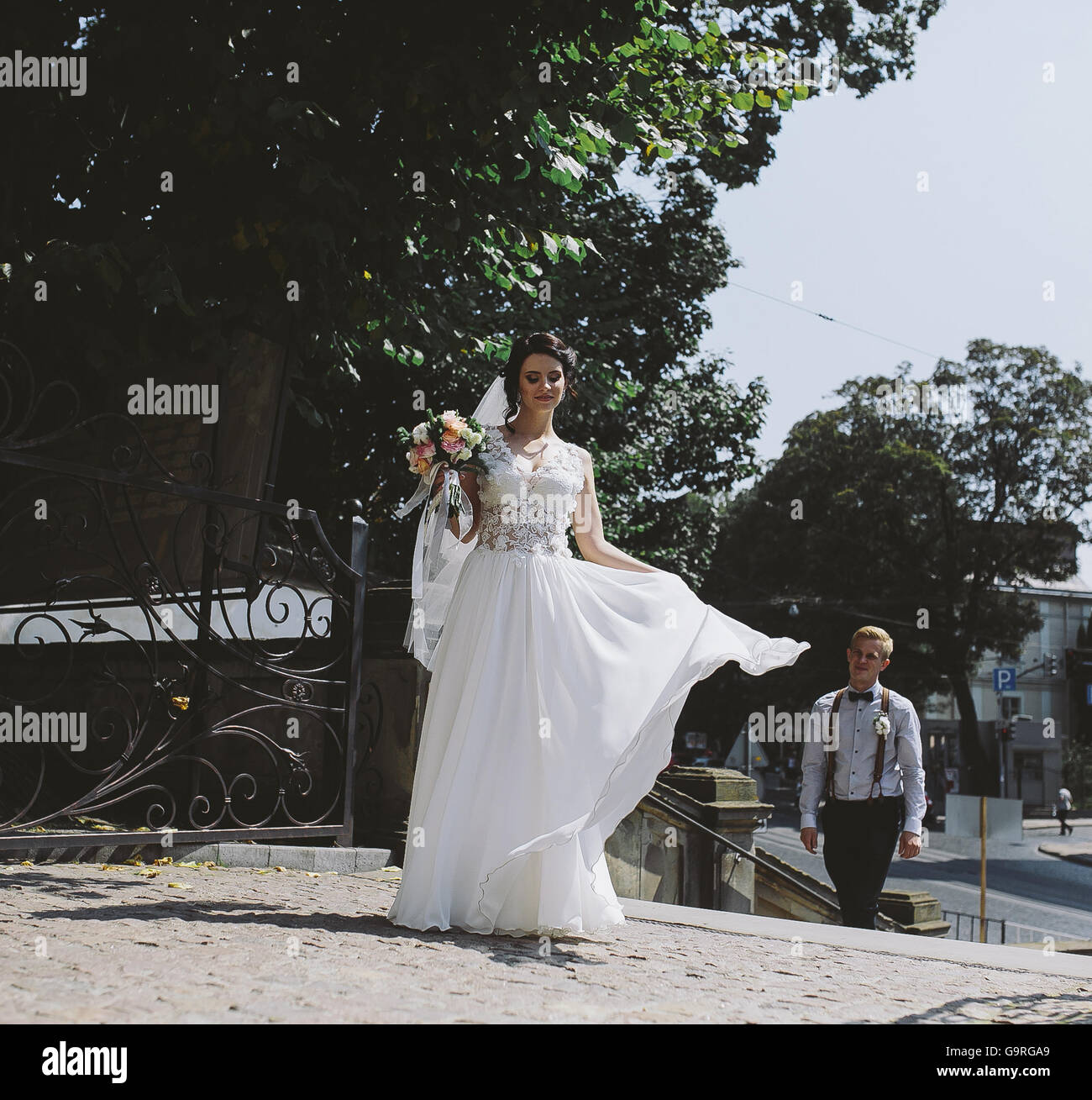 bride and groom posing on the streets Stock Photo - Alamy