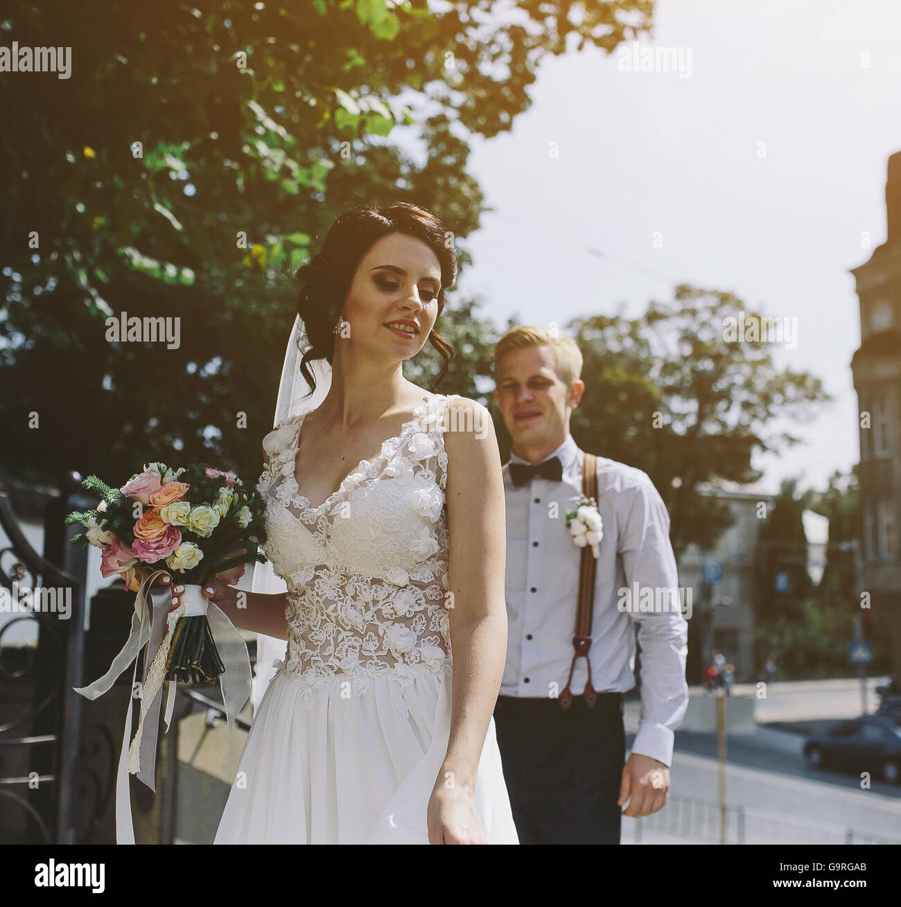 bride and groom posing on the streets Stock Photo - Alamy