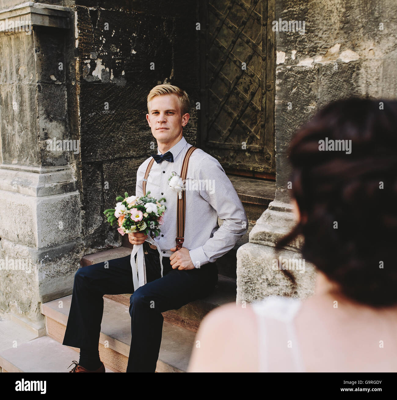 bride sitting on stone steps Stock Photo - Alamy