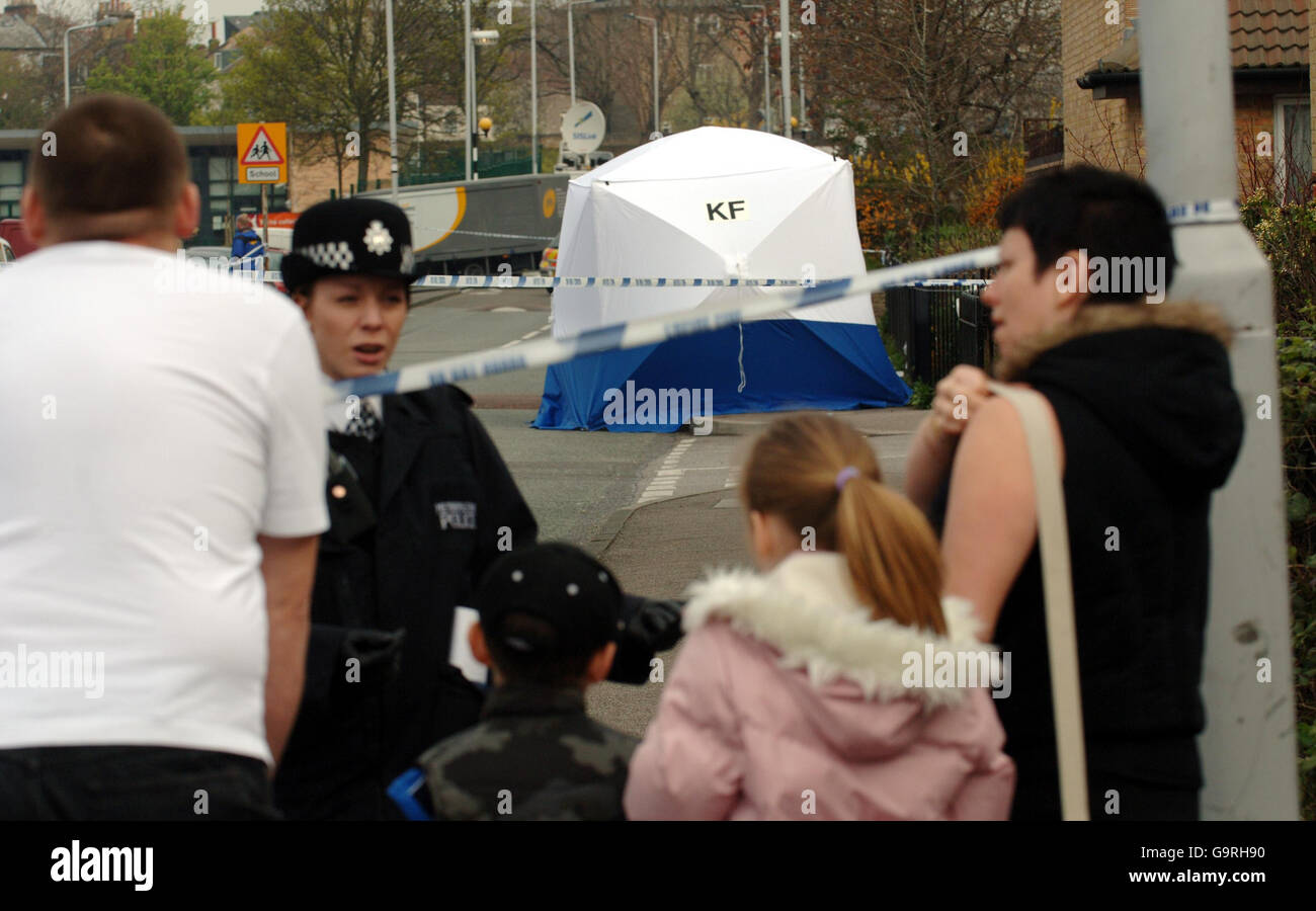 Police officers stand on Hall Road in Leytonstone, East London, after a