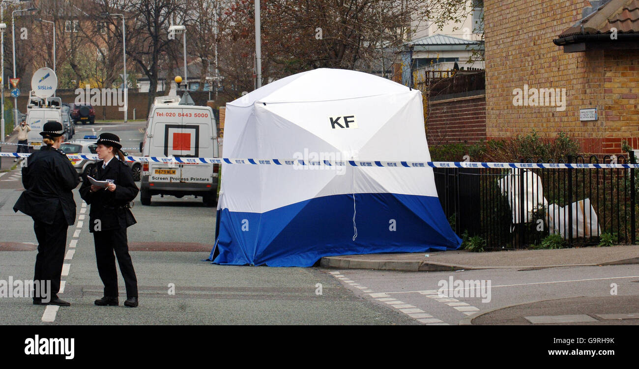 Police officers stand on Hall Road in Leytonstone, East London, after a