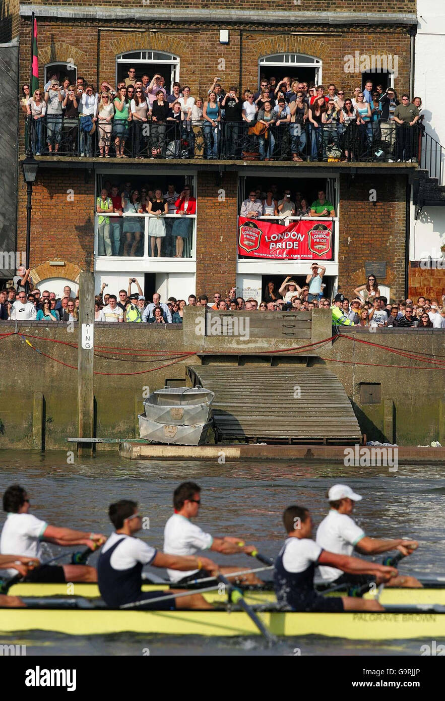 Supporters cheer on the Oxford and Cambridge University rowing teams at Hammersmith during the 153rd Boat Race today. Stock Photo