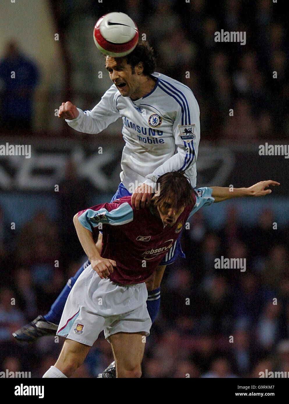 Chelsea's Ricardo Carvalho (top) climbs high to beat West Ham United's Yossi Benayoun to the ball during the FA Barclays Premiership match at Upton Park, London. Stock Photo