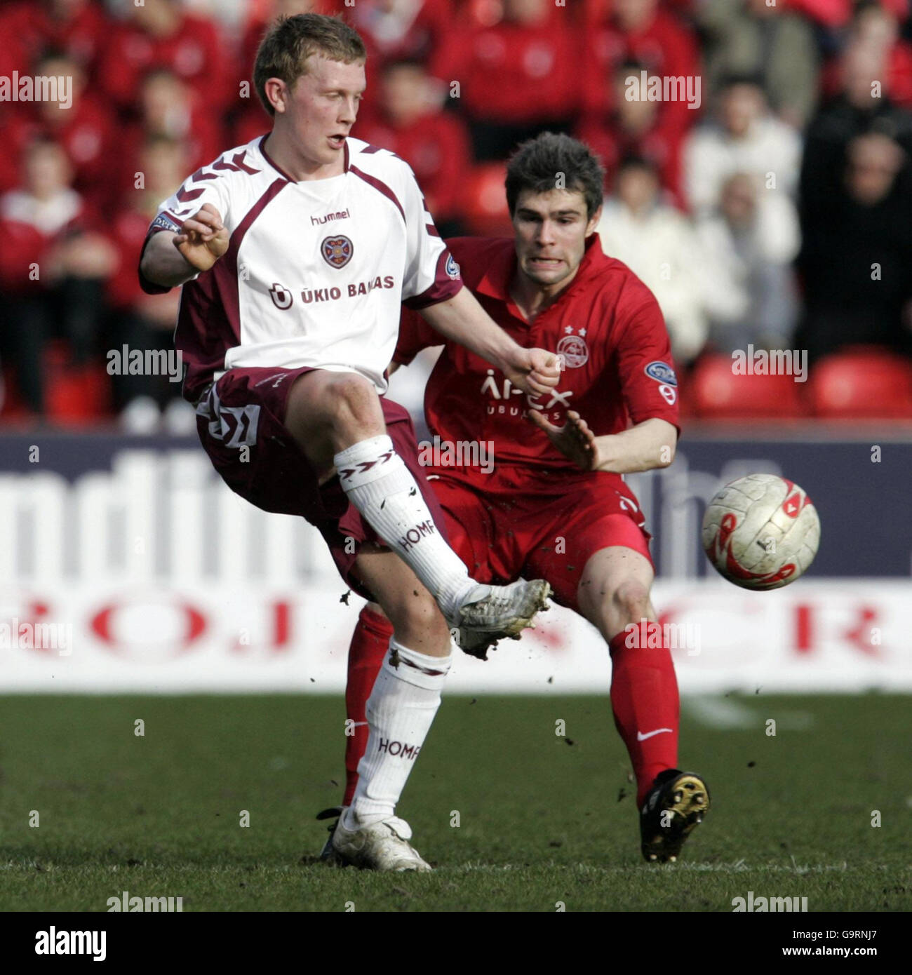 Aberdeen's Michael Hart (right) looks to challenge Hearts' Andrew ...