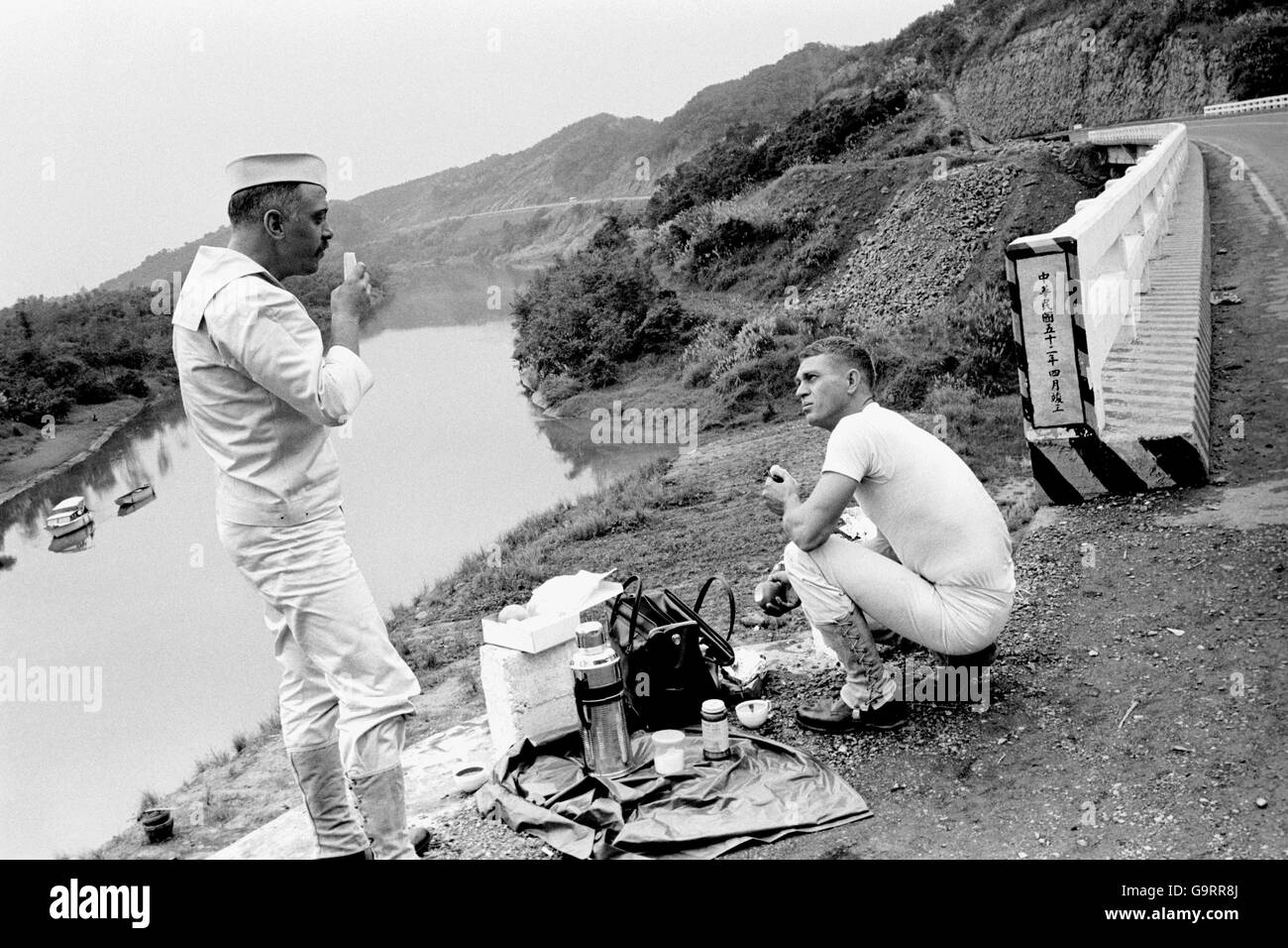 Richard Attenborough and Steve McQueen enjoying a picnic lunch of the banks of the Tam Sui River in Formosa, during filming of the the film 'The Sand Pebbles'. 21/3/1966 Stock Photo