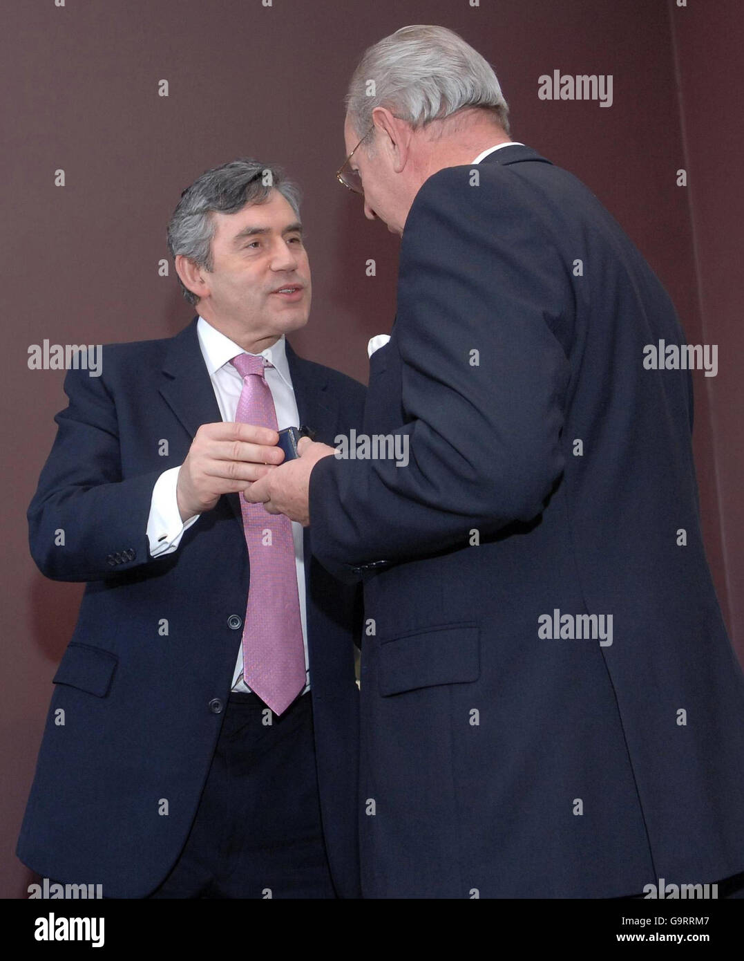Royal Enginneer veteran Michael Warren receives his 'Armed Forces Veteran's Badge' from Chancellor Gordon Brown at the Imperial War Museum in London today. Stock Photo