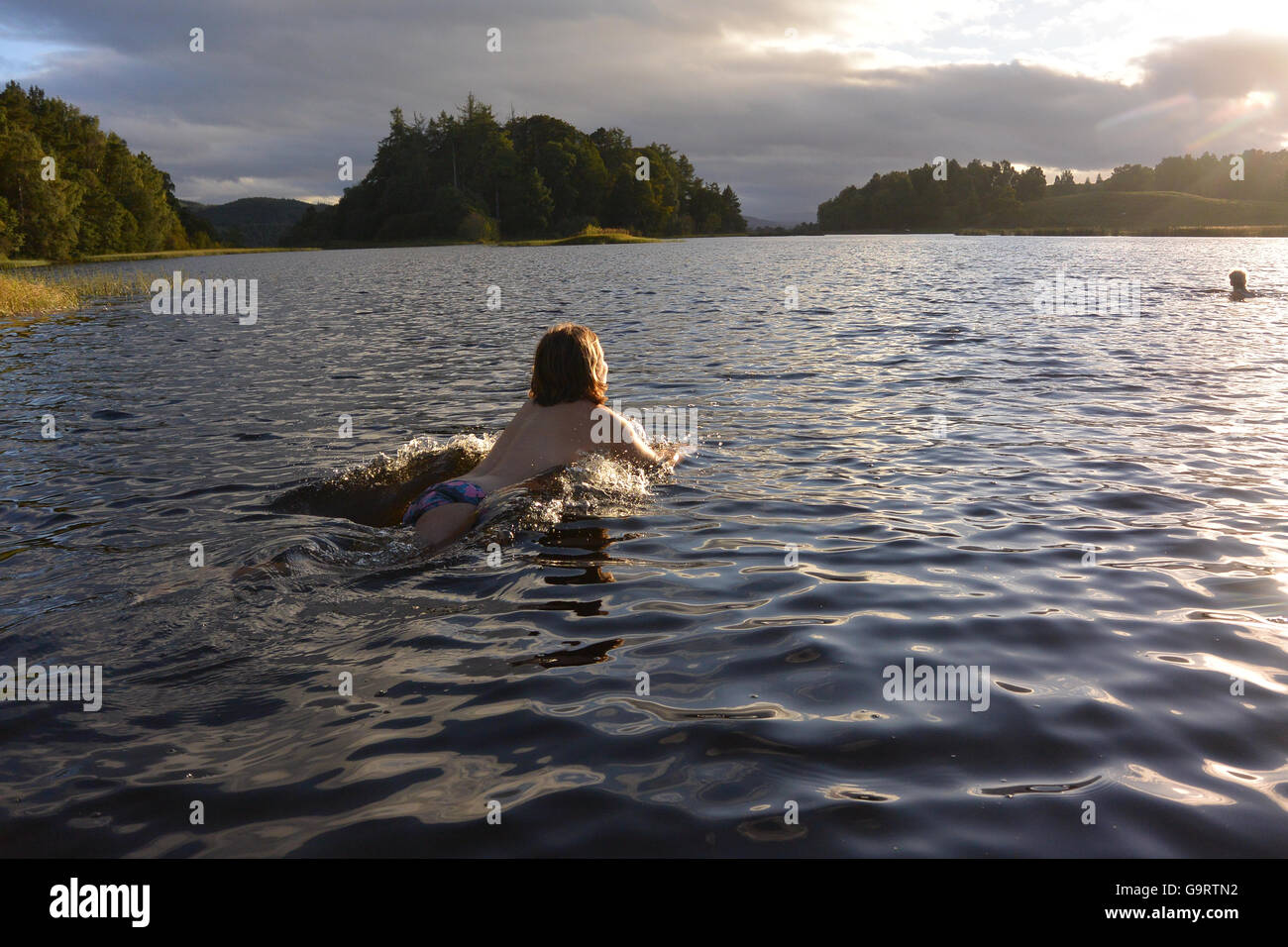 Jumping into Loch Insh at the start of the rive Spey Stock Photo