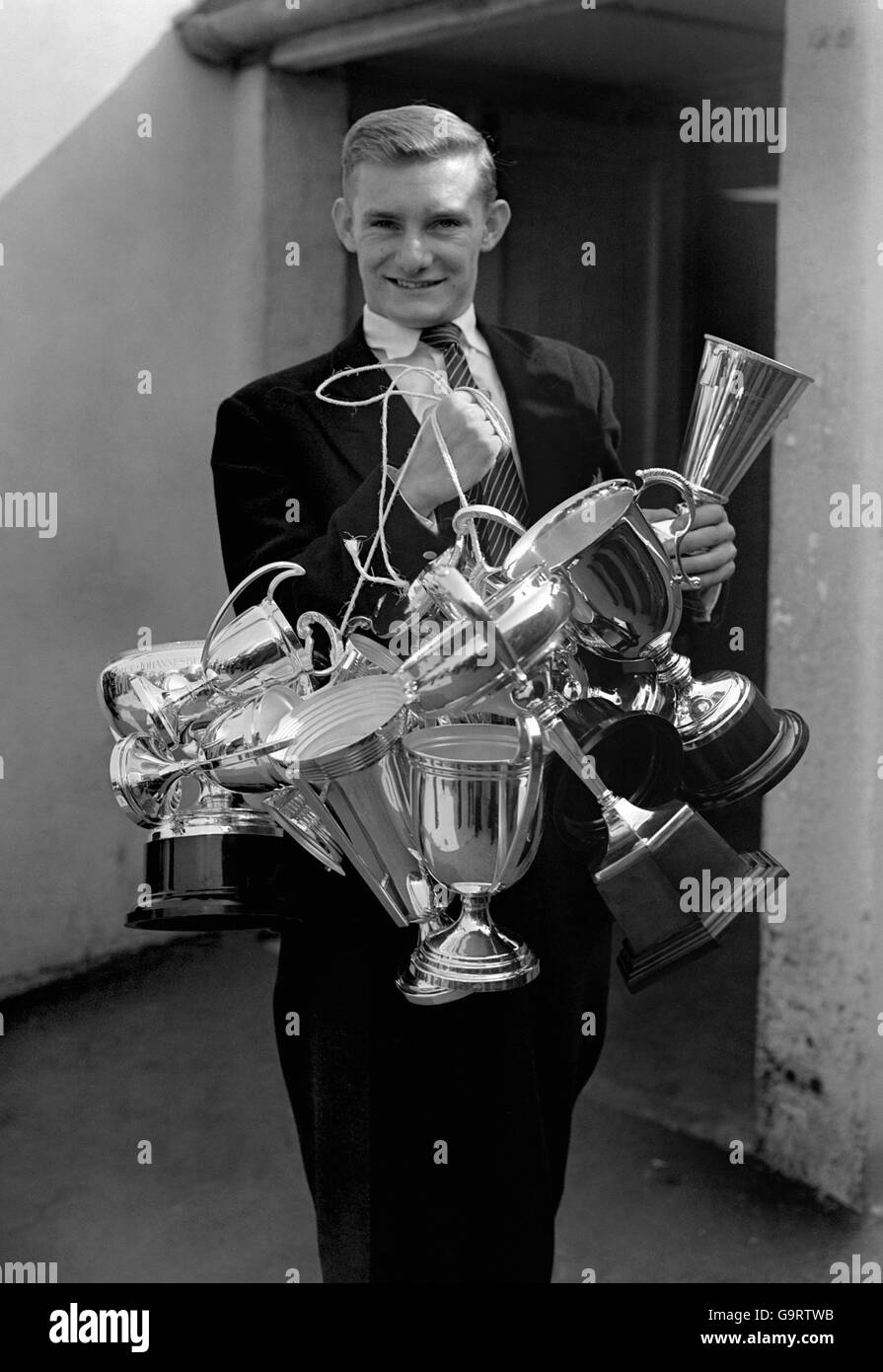 Motorcycle Grand Prix Champion Mike "The Bike" Hailwood MBE, laden with his  collection of trophies Stock Photo - Alamy