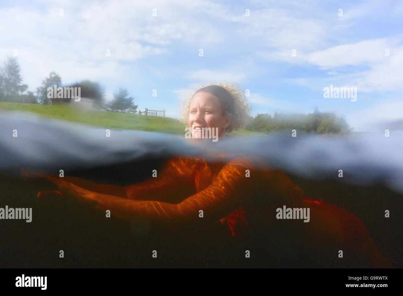 Wild swimming in the tannin tinted waters of the river Spey Stock Photo