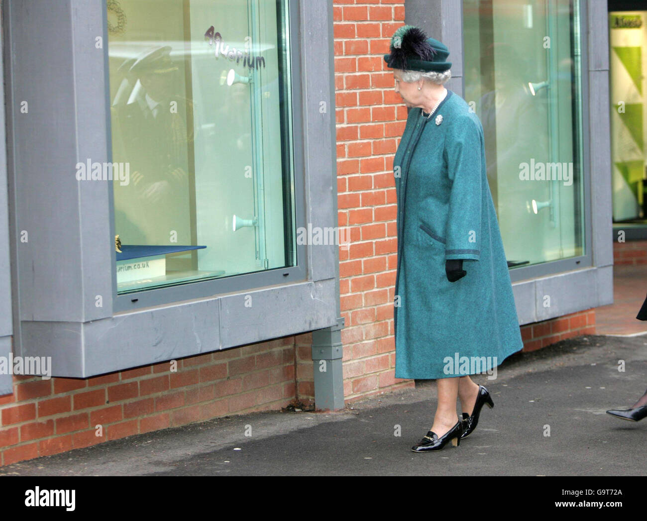 Britain's Queen Elizabeth II looks at window displays which are part of