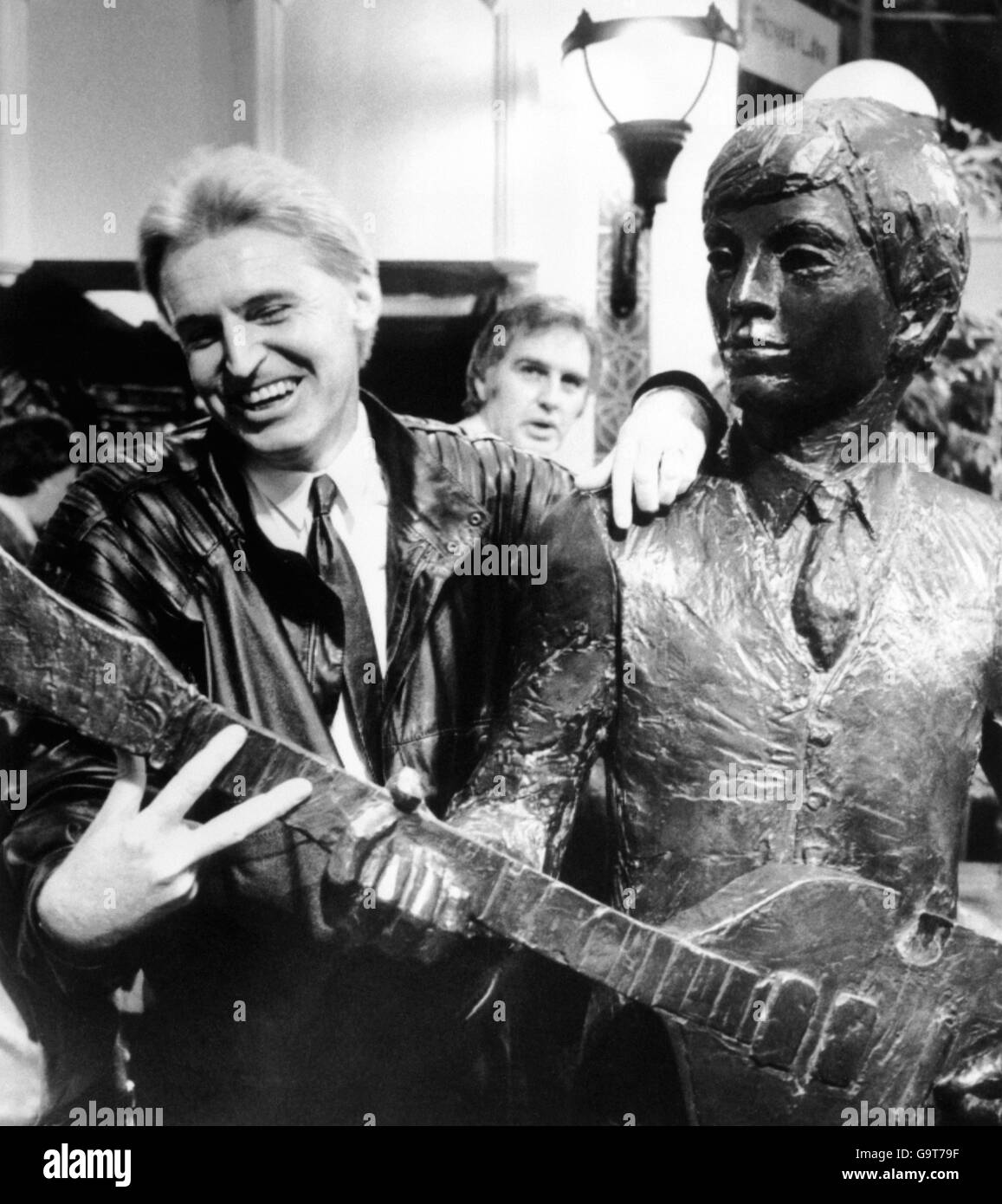 Mick McGear brother of former Beatle Paul McCartney becomes part of a duet with the figure of Paul. A section of the Beatles sculpture unveiled in the Cavern Walks, Liverpool Stock Photo